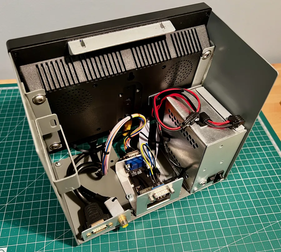 Click to view full size - Showing the inside of the terminal – it's built around a small LCD monitor with 12V to 5V converter on the right. The FabGL terminal is the small board in the middle, and the additional inputs to the LCD are available on the back. I originally built this to house a full Raspberry Pi before changing to the FabGL